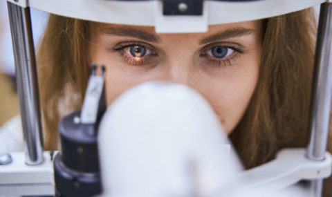 Young woman having eyesight examining in clinic